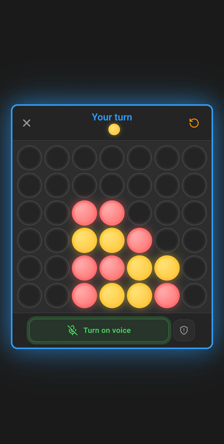 A Connect Four match on Play Lounge with the push-to-talk voice control visible below the board